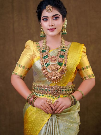 This silver and yellow silk saree creates a unique and elegant look. The draping is done to show off the beautiful contrast border and the richness of the silk.