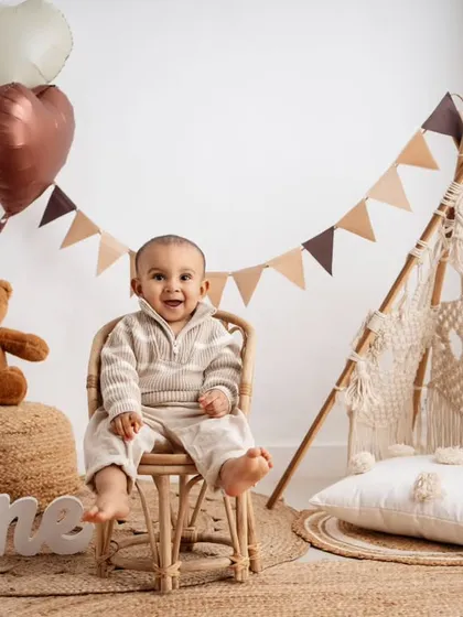 My popular boho theme, complete with a macrame teepee and natural textures, creates a warm and stylish setting for your baby's first birthday pictures.
