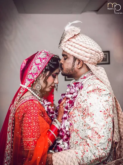 A tender moment on the wedding day. The groom's gentle kiss on the bride's forehead is a classic shot that I love to capture, as it speaks volumes about their love and care for each other.
