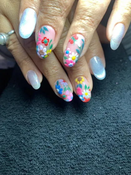 A lovely floral design with a sheer, shimmery base and accent nails covered in colorful, hand-painted flowers.