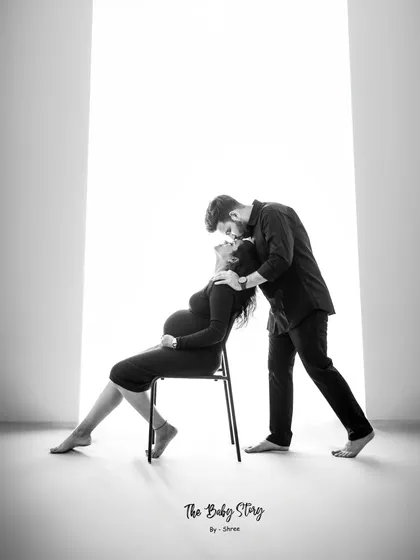 A quiet, powerful moment between a couple, captured in black and white. This artistic shot uses dramatic lighting to highlight the connection and anticipation, creating a timeless piece of art.