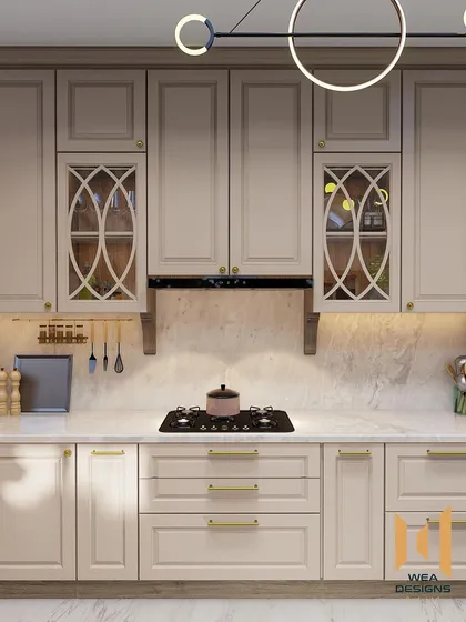 A neoclassical kitchen with a modern twist, featuring warm beige cabinets with classic moulding and intricate glass shutter designs.