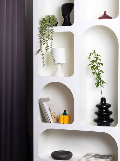 A detailed view of our styled arched shelves, showing how various props like vases, books, and plants can be arranged to create a personalized and aesthetic background.