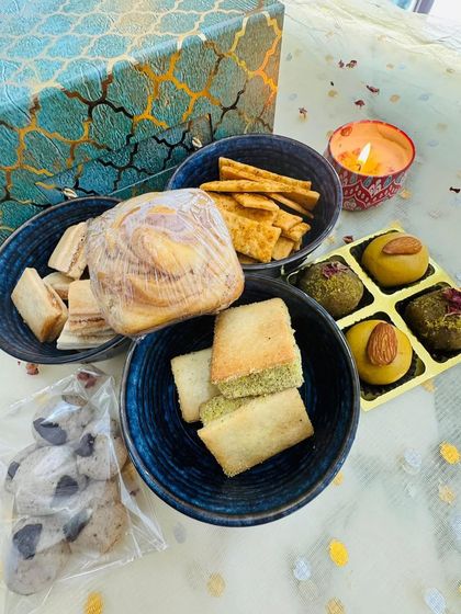My premium "Swaad-e-Diwali" gift hamper is a feast for the senses. It includes a wide assortment of my fusion and classic treats, like Nankhatai Sandwiches, Besan Laddoos, and a Marbled Biscoff Cube Cake.
