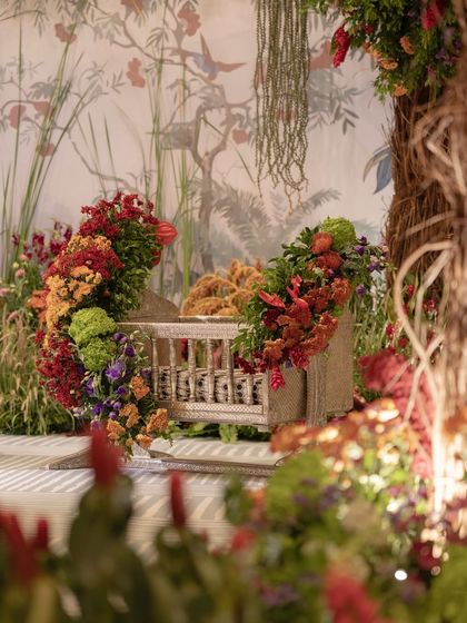 The traditional cradle or 'thottil' at the naming ceremony, beautifully decorated with flowers.