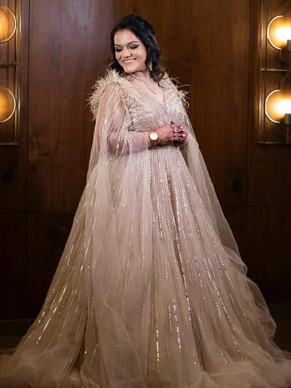 A full-length shot of the bride in her magnificent gown. The makeup is glamorous yet sophisticated.