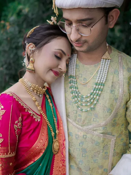 An intimate and tender portrait of the bride resting her head on the groom's shoulder, a moment of peace and connection on their wedding day.