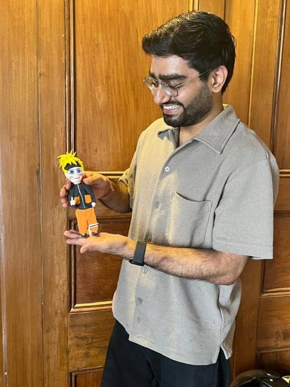 A participant proudly holds up his handmade Naruto figurine. Our workshops are a space to bring your favorite characters and ideas to life in clay.