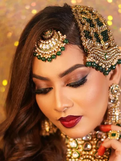 A close-up of the Muslim bridal look, focusing on the dramatic winged eyeliner and bold red lip.