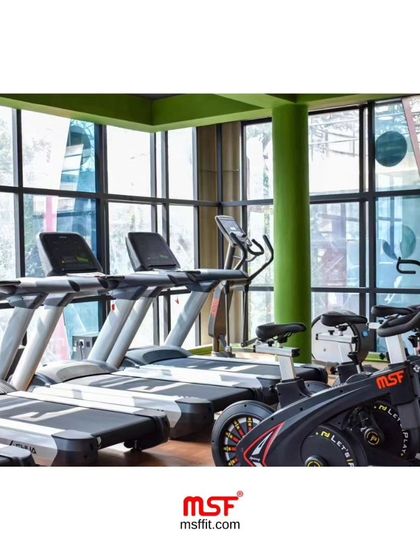 A row of our commercial treadmills and spin bikes installed at a client's gym. We ensure optimal layout for user flow and space efficiency, providing a great view for members while they train.