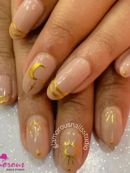An elegant and artistic design featuring a nude base with hand-painted gold celestial motifs like suns and moons.