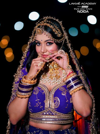 A regal bridal look in a royal blue lehenga. We teach our students to work with bold colors and create looks that are both traditional and striking.