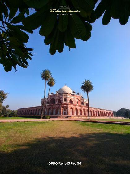 Another perspective of Humayun's Tomb, framed by lush greenery, shot on the OPPO Reno13 Pro. This demonstrates creating a variety of compositions for a brand campaign using the same device.