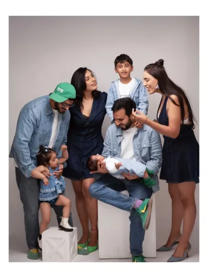 A candid and interactive shot of an extended family dressed in coordinated denim outfits. We help pose large groups to create a balanced and connected composition.