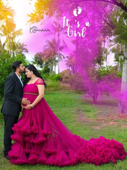 A sweet gender reveal photo with a pink smoke bomb to announce "It's a girl!".