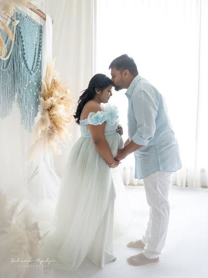 A sweet kiss on the forehead. This gesture of love and protection from the dad-to-be makes for a truly heartwarming and memorable maternity portrait.