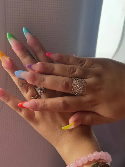 Getting ready for a vacation? I created these fun, colorful vacation nails using a rainbow gradient on the tips for a modern twist on the classic French manicure.