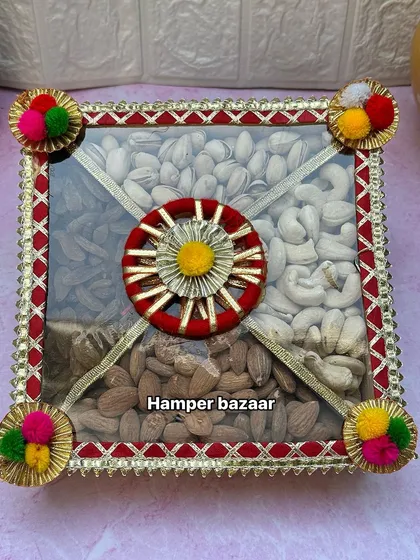 Our dry fruit trays are a classic Diwali gift. This one is presented in a beautifully decorated pinewood box with four sections, filled with premium almonds, cashews, and pistachios.