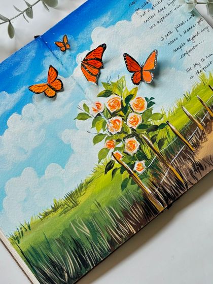 A beautiful landscape spread in my sketchbook, featuring a field of roses, a country path, and 3D paper butterflies that seem to fly off the page.