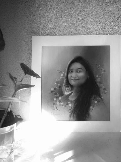 The finished portrait displayed in a home setting, showing how the white art mount makes the artwork stand out.