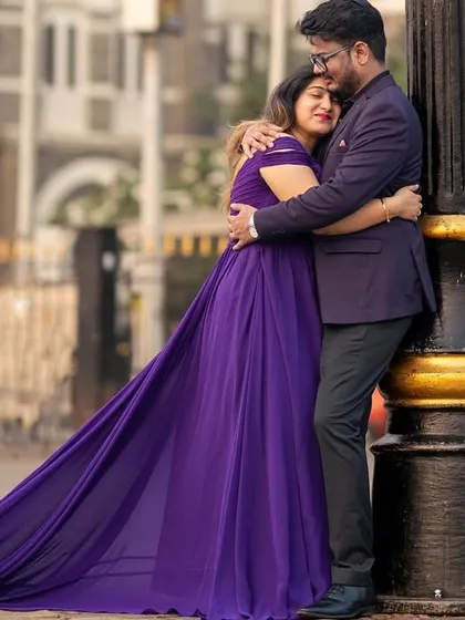 An embrace in the city. The long purple trail of the gown adds a touch of drama and romance to this urban pre-wedding photoshoot.