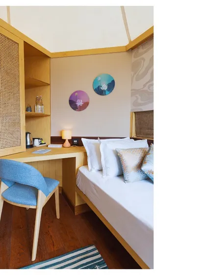 A glimpse of Somya's work, showcasing a cozy and functional bedroom nook with natural materials like cane and wood.