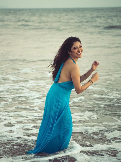 A candid, happy moment captured as the model plays in the surf. It's a shot full of life and positive energy.