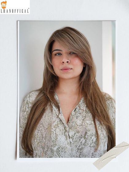A straight-on view of the ice blonde transformation. The side-swept bangs and soft layers complement the cool color, framing the face beautifully.