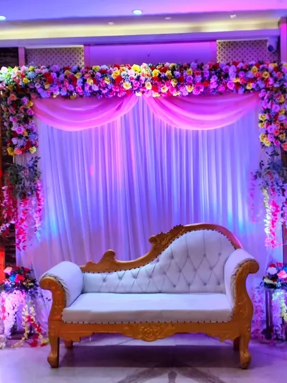 Another angle of the reception stage, showing the full floral frame and the soft, ambient lighting created by spotlights.