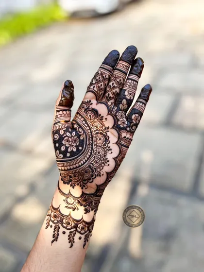 The same modern floral design, captured from a different angle. The dark, solid-filled fingertips provide a beautiful contrast to the detailed work on the palm and wrist.