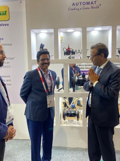 Our founder, Shri P.K. Jain, warmly greeting a visitor at our PlastIndia booth. His presence underscores our company's deep-rooted experience and commitment to the industry.
