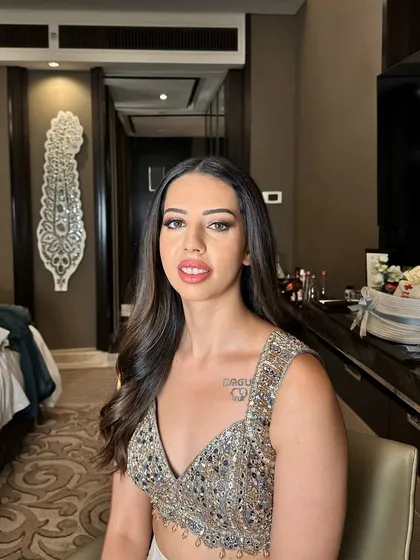 Sangeet glam with a focus on shimmering eyes and a flawless base. This look is perfect for an evening of celebration, designed to be long-lasting and picture-perfect from every angle.