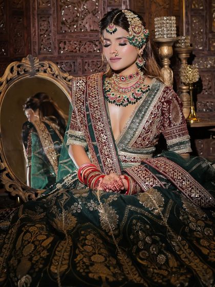 A set of three images of a bride in a green and maroon velvet lehenga. These shots capture the regal essence and are perfect for a traditional bridal lookbook.