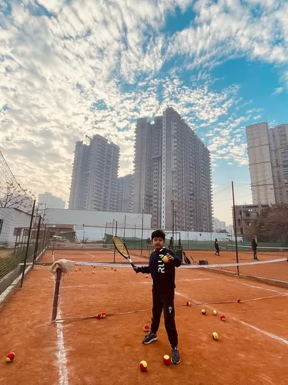 A young player ready for action on the mini-tennis court.