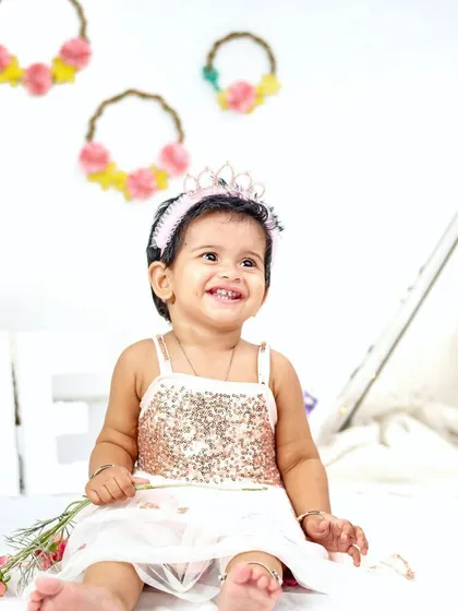 We love capturing the pure happiness of a first birthday portrait session. Her bright smile and adorable outfit make for a timeless photo before the cake is even introduced.