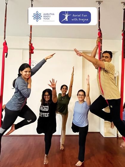 Our aerial yoga group exploring poses with smiles and enthusiasm. This practice is a great way to build community while discovering the freedom of movement.