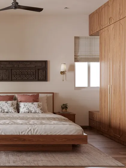 For this bedroom, I blended modern Indian aesthetics with classic comfort. The carved wooden panel above the bed adds a traditional touch, while the clean lines of the furniture and the warm wood tones of the wardrobe create a cozy and timeless feel.