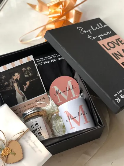A "Love in a Box" hamper for Valentine's Day. This one features a personalized mug and coaster, a scented candle, and a sweet photo to capture a special moment.