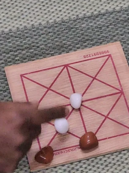 A close-up of one of the traditional board games played during our workshop. These games, which seem simple, require strategic planning and are a great way to build logical reasoning skills.