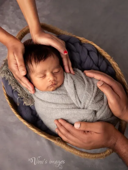 Another angle of the protective hands pose, showing the delicate nature of the newborn nestled safely within the parents' embrace. It's a simple yet profound image.