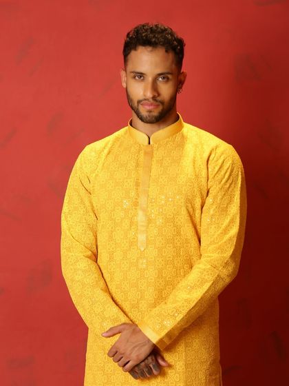 Jab dost ki haldi ka ho invite, a yellow kurta is always right. A close-up of a model in a vibrant yellow kurta, perfect for the occasion.