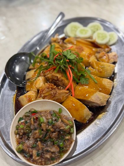 This is my version of a classic Hainanese steamed chicken. The chicken is poached until it's incredibly tender and juicy, then served with a flavourful soy sauce dressing, fried garlic, and a zesty ginger chili dip on the side.