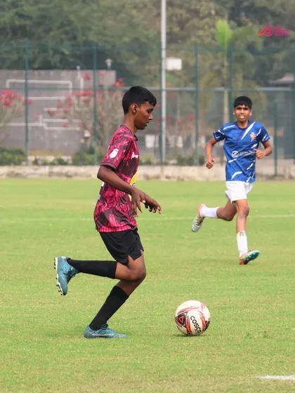 An intense moment of play as our player dribbles past an opponent during a match.