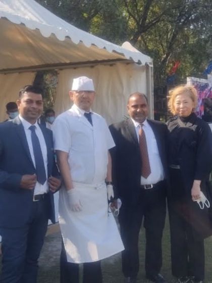 Our professional team on-site at an outdoor event. Dressed in sharp uniforms, our managers, chefs, and service staff work together to deliver a flawless catering experience for our clients and their guests.