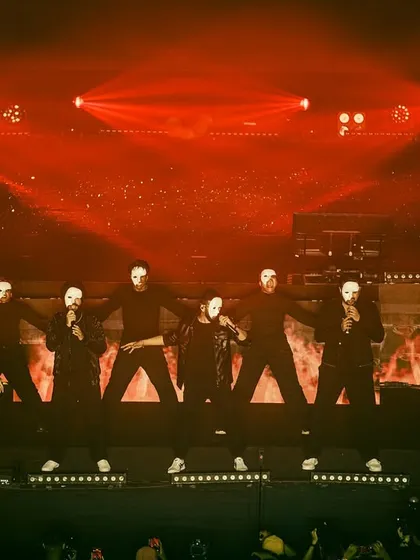 The power of formation and costume in a live concert setting. For this piece, we used stark black outfits and masks under dramatic red lighting to create a powerful and memorable visual statement.