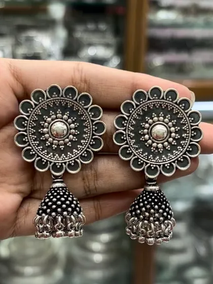 The perfect oxidised silver jhumka to go with all your fits. This classic design features a large floral stud and a perfectly proportioned jhumka drop.