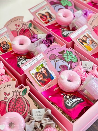 A collection of our pink-themed bridesmaid hampers, each with a donut soap, Hershey's Kisses, and a personalized card.