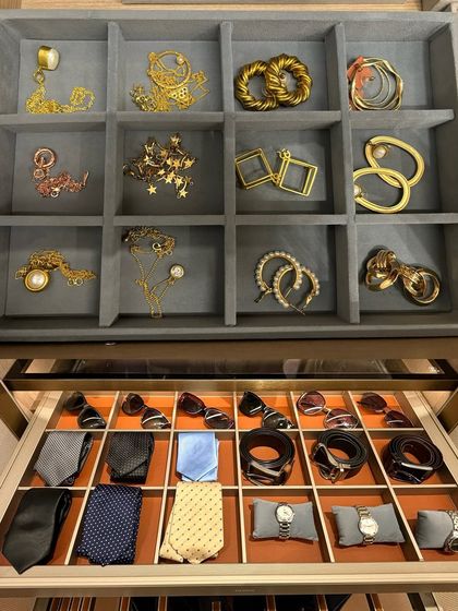 This image combines our jewellery and men's accessory drawer solutions. On top, a grey velvet tray for earrings; below, a custom insert for ties, watches, and sunglasses.