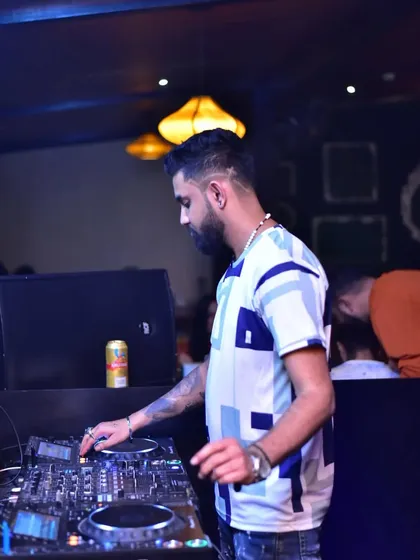A candid shot of me in the zone, focused on the mixer. These speakers might look small, but they pack a serious punch, and I make sure every beat is heard.