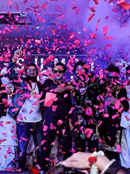 A shower of pink confetti over the stage at a Diwali party. This explosive moment of celebration is a fantastic photo opportunity that shows the peak excitement of the event.